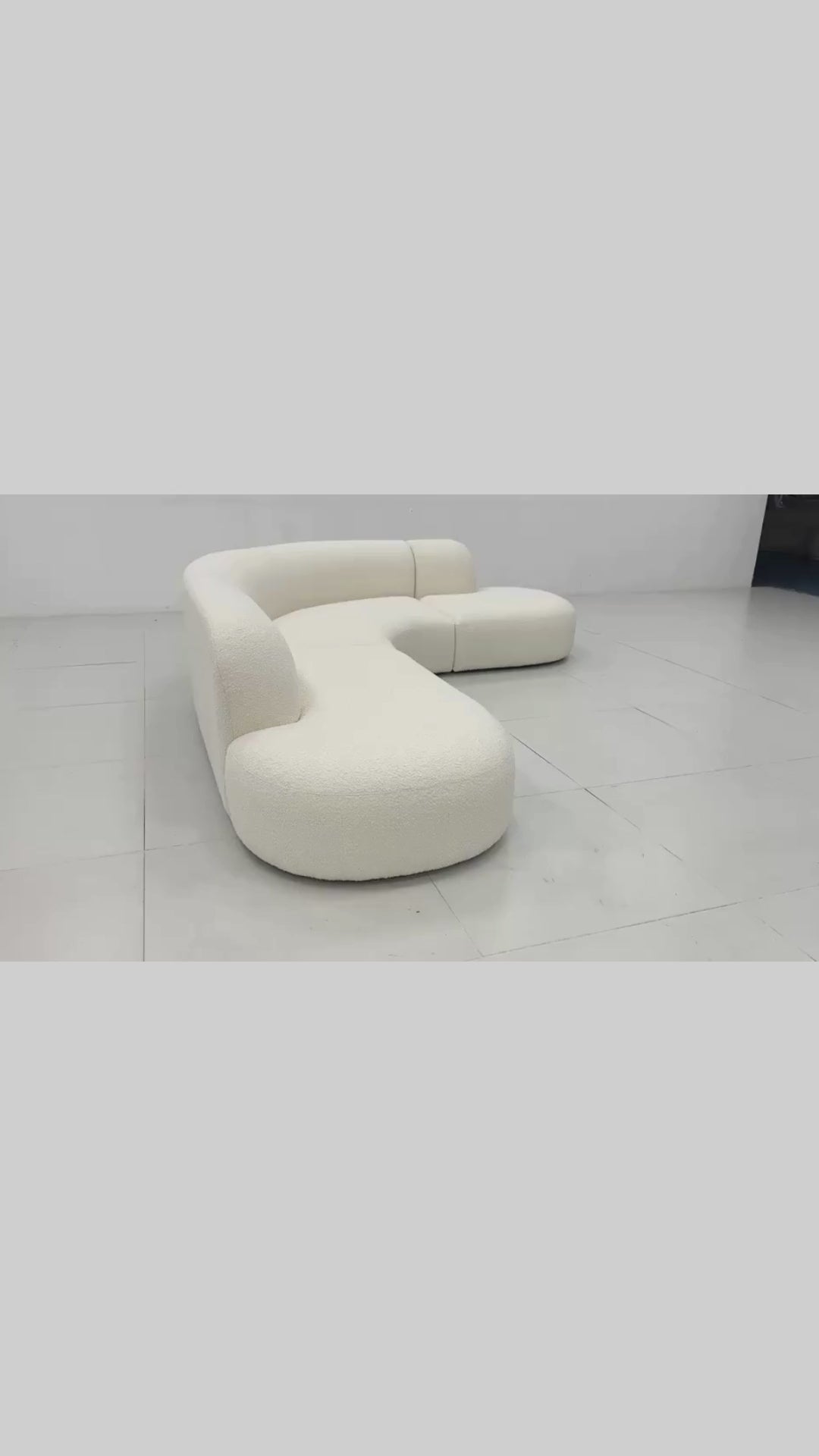 Modern curved sofa in boucle fabric with cushions