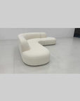 Modern curved sofa in boucle fabric with cushions